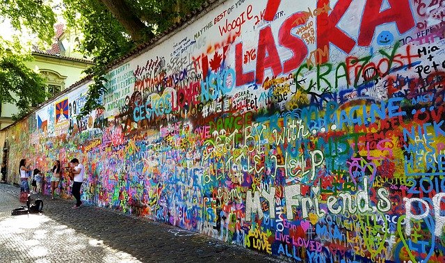 Musicans infront of John Lennon Wall